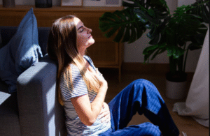 Woman practicing deep breathing exercise for stress management in Houston
