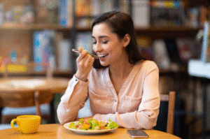 Woman eating a healthy balanced meal to support stress management in Houston