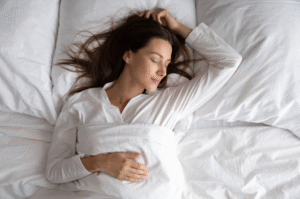 Woman sleeping peacefully to improve stress management in Houston