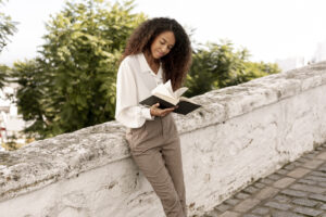 Woman reading outdoors and reflecting, symbolizing Christian counseling and spiritual guidance.