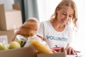 Woman smiling while volunteering, representing how serving others reduces anxiety