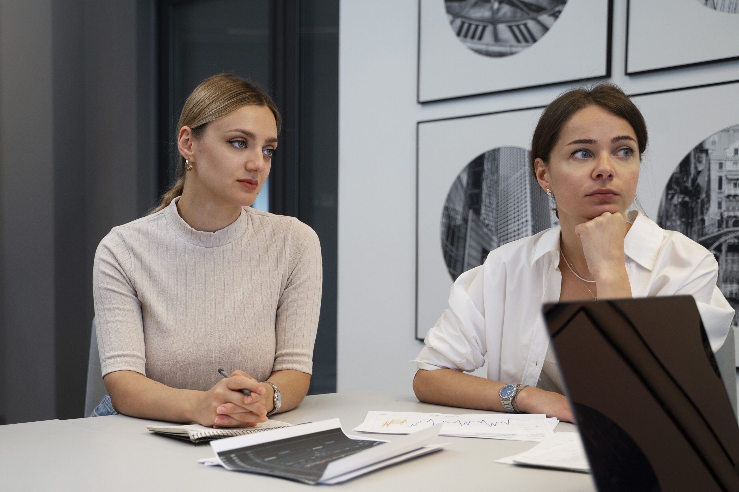 Two women sitting across from each other in conversation, one looking uncertain, representing the difference between manipulation and healthy communication in relationships